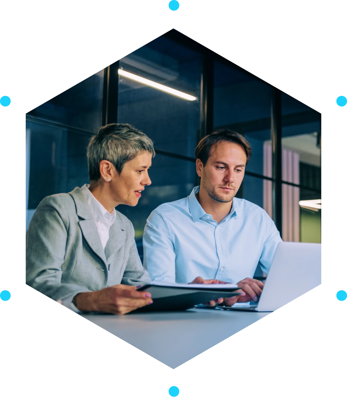 Two professionals working on a laptop